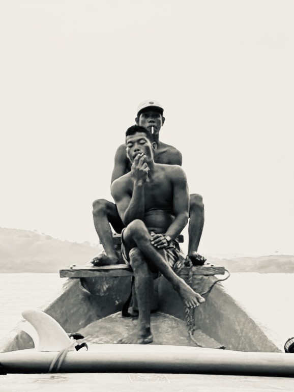 Surf coaches having a cigarette break on boat